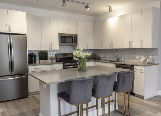 a kitchen with stainless steel appliances and white cabinets