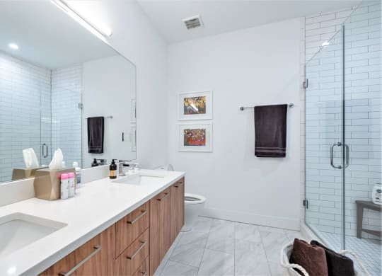 a bathroom with a large mirror and a sink and a shower