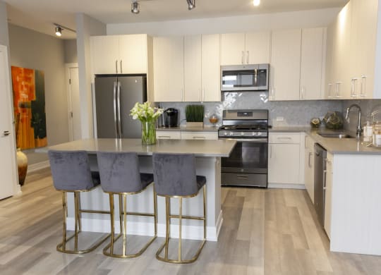 a kitchen with stainless steel appliances and white cabinets