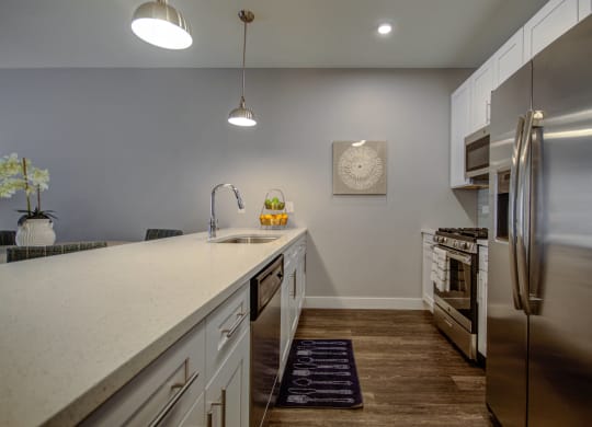 a kitchen with a large counter top and a stainless steel refrigerator at Barrington 101, Illinois