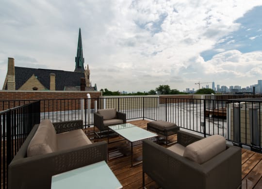 a rooftop deck with furniture and a view of the city  at Tripp 4321, Chicago, 60641