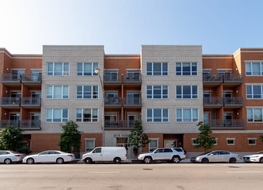 a large apartment building with cars parked in front of it  at Tripp 4321, Chicago, 60641