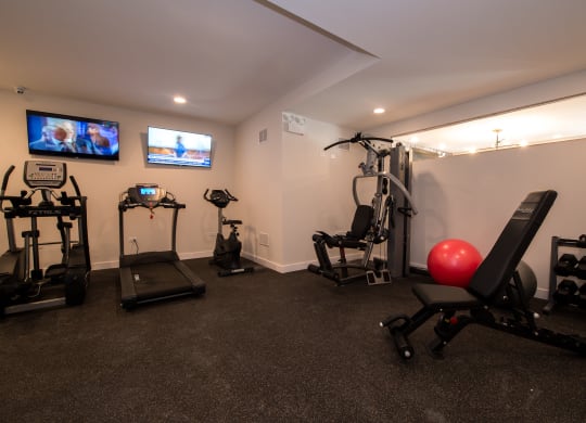 a home gym with exercise equipment and a tv
