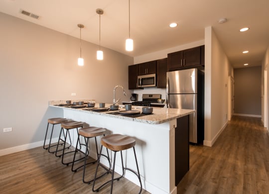 a kitchen with a large island with four stools