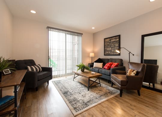 a living room with a couch and chairs and a table