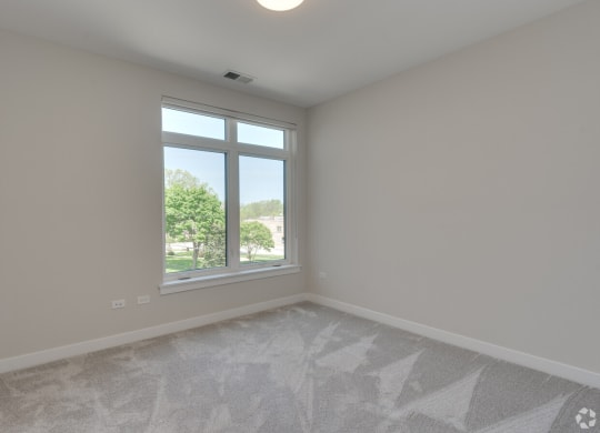 an empty living room with a large window