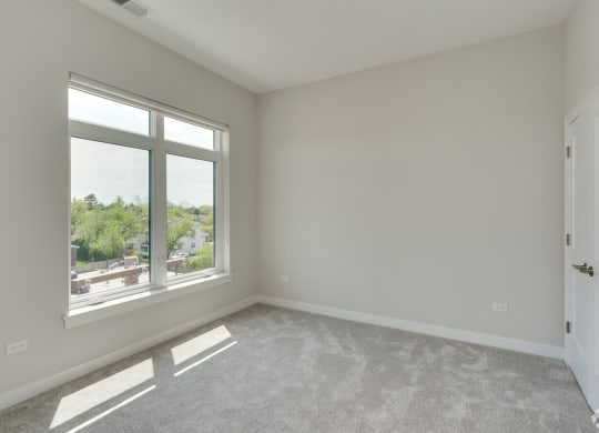 an empty living room with a large window