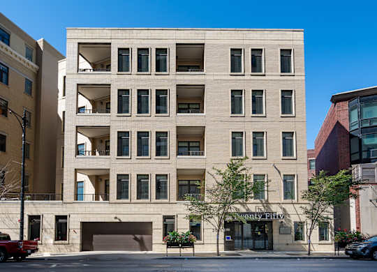 A large building with a garage door and a sign that says