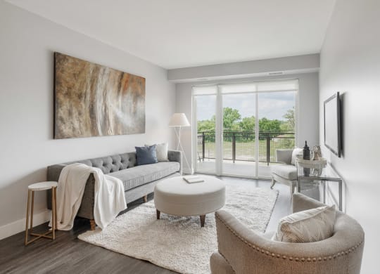 a living room with a couch and a chair and a balcony at Barrington 101, Barrington, IL 60010