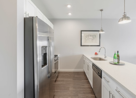 a kitchen with stainless steel appliances and white cabinets at Barrington 101, Barrington, IL