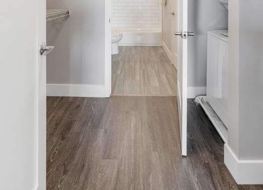 a white bathroom with a toilet and a walk in closet at Barrington 101, Chicago
