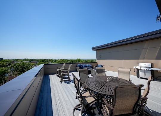 a patio with a table and chairs on a roof