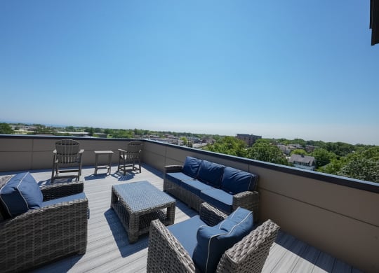 a roof deck with furniture and a view of the city