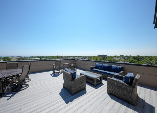 a roof deck with furniture and a view of the city
