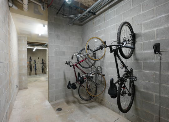 a basement room with two bikes hanging on the wall