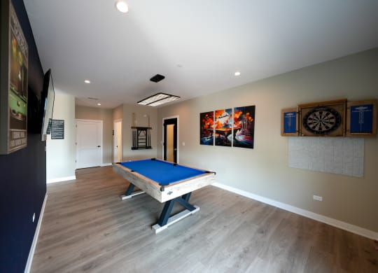a rec room with a pool table in a house