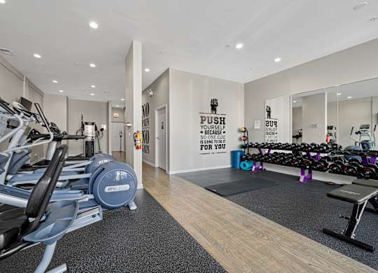 A gym with a row of treadmills and a sign that says