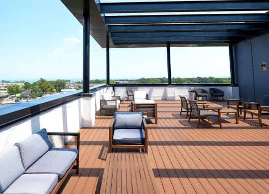 a deck with couches and tables on top of a roof