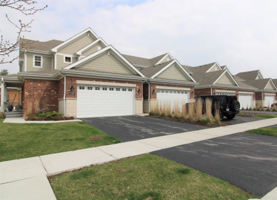 a house with a white garage door in front of it at Countryside Townhomes, Countryside, IL