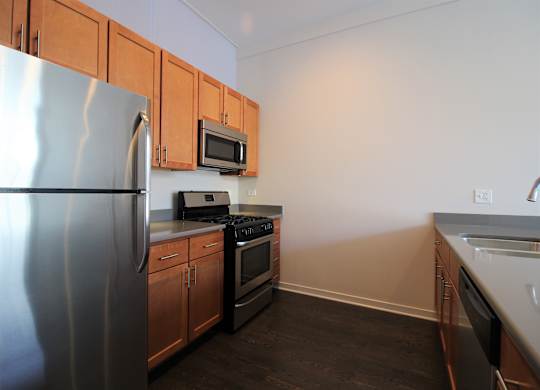 a kitchen with stainless steel appliances and wooden cabinets