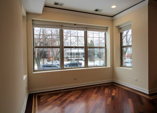 the living room of a new home with wood floors and large windows
