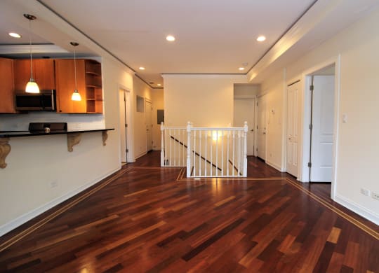a living room with a hard wood floor and a staircase