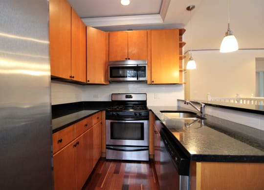 a kitchen with wooden cabinets and stainless steel appliances