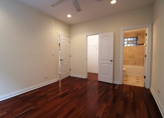 a living room with a hard wood floor and two doors