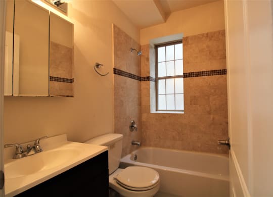 a bathroom with a sink toilet and a bath tub