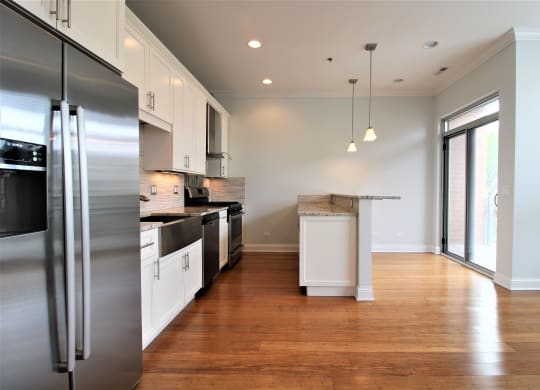 a kitchen with stainless steel appliances and white cabinets