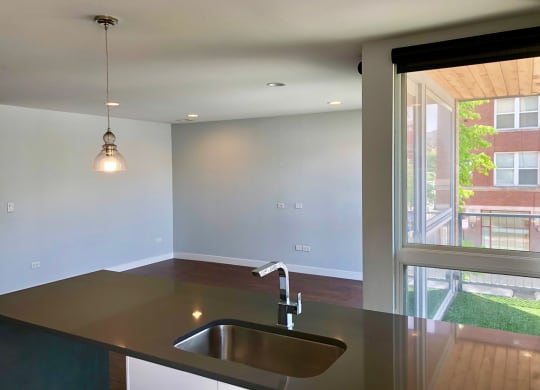 an empty kitchen with a sink and a window