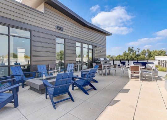 the patio of the building has blue chairs and tables at Barrington 101, Chicago