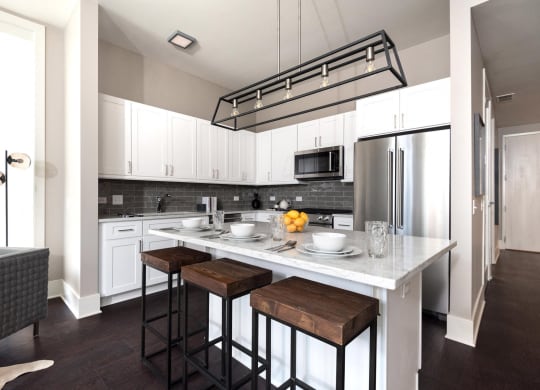 a kitchen with a center island and three stools