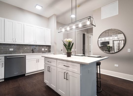 a kitchen with white cabinets and a white counter top