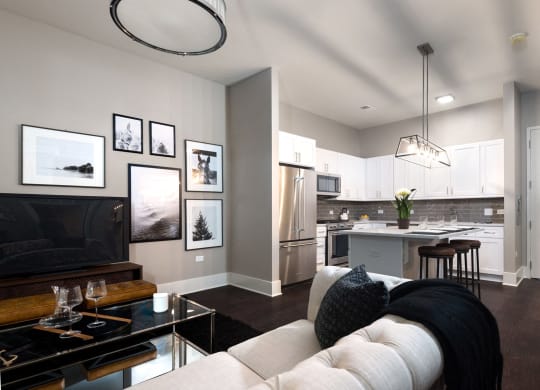 a living room with a white couch and a kitchen