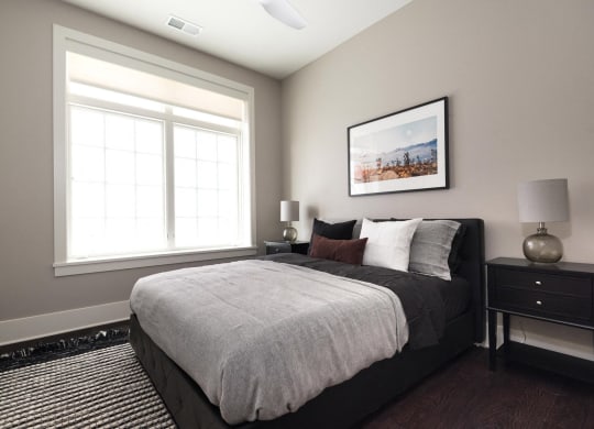 a bedroom with a large bed and a window