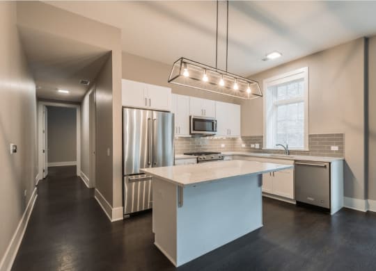 a kitchen with white cabinets and a white counter top
