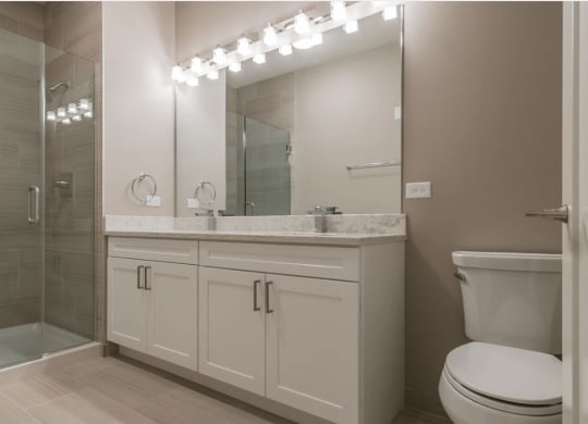 a bathroom with a sink toilet and a shower