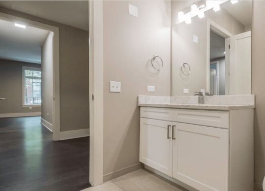 a bathroom with a toilet and a sink and a mirror