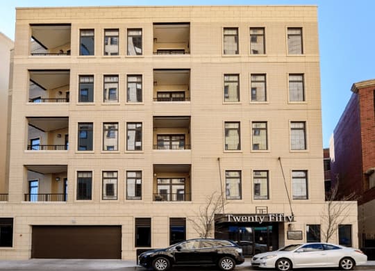 a large tan building with cars parked in front of it  at Clark 2050, Chicago, Illinois