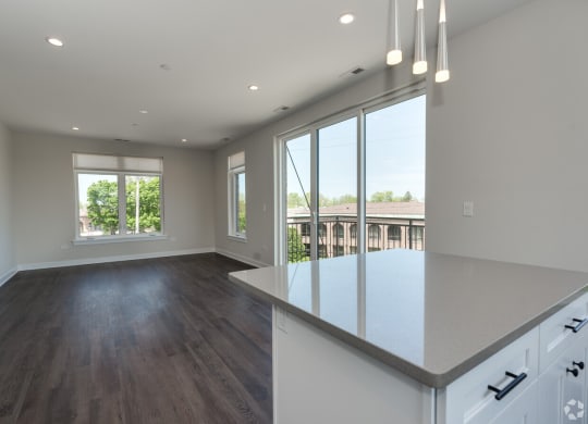 an open kitchen and living room with a large window