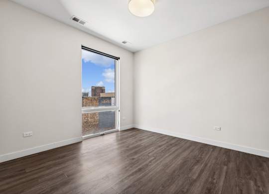 Bright bedroom at Highpoint Buena Park on Broadway, part of a selection of modern 1, 2, 3, and 4-bedroom apartments in Chicago’s Buena Park neighborhood, featuring large windows and contemporary finishes