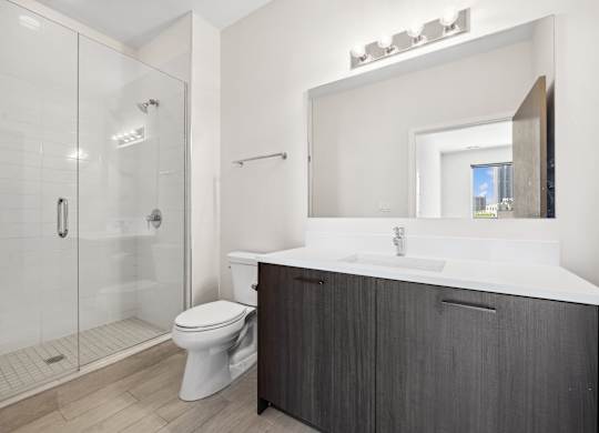 Modern bathroom at Highpoint Buena Park on Broadway featuring sleek tilework, contemporary fixtures, and ample vanity space in a luxury Buena Park apartment in Chicago