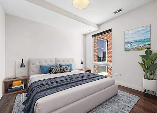 A bedroom with a large bed and a painting on the wall.