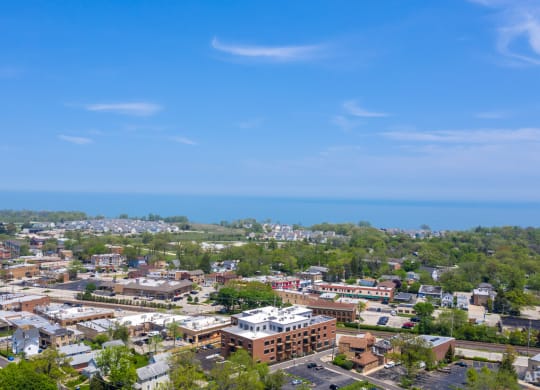 an aerial view of a city with the ocean in the background