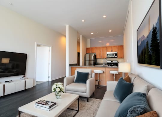 a living room and kitchen with a couch and a table