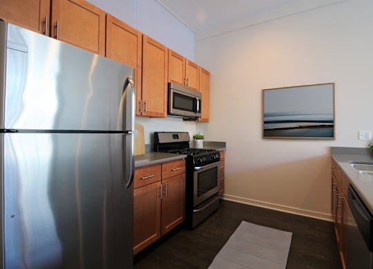 a kitchen with stainless steel appliances and wooden cabinets