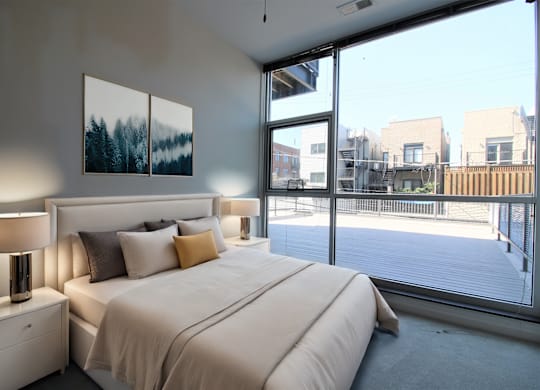 a bedroom with a large bed and a large window