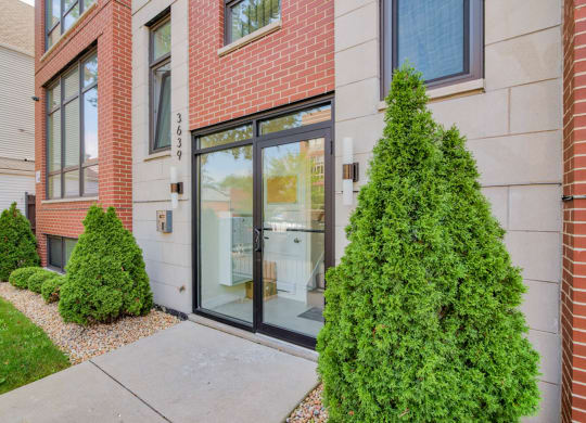 a sidewalk in front of a building with a glass door at Montrose 3634, Chicago