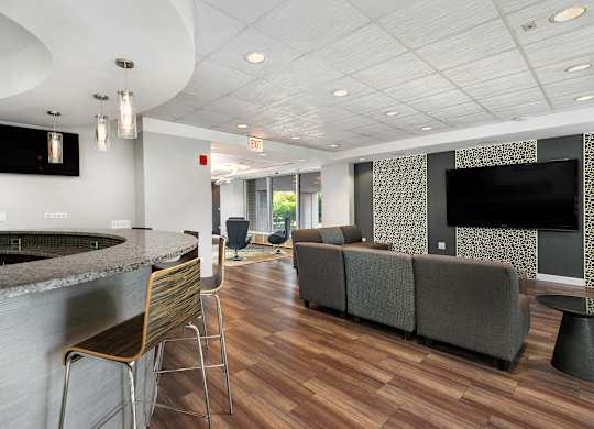 A modern living room with a bar area and a television.
